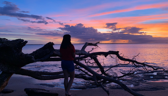 CDU student Srijana Ghimire watching the sunset on a beach