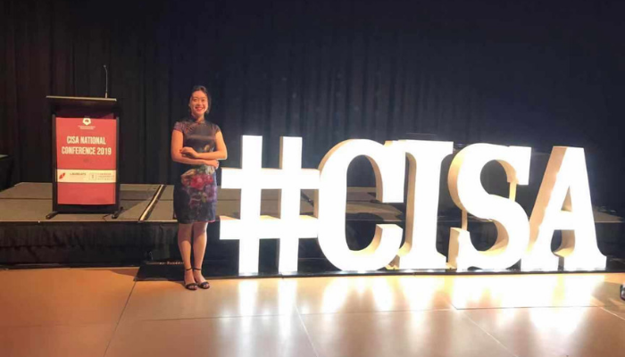 Vicky standing and smiling