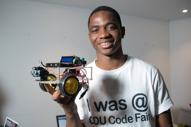 Joel Benesha holding his robot