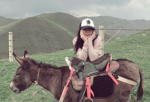 Chengxi Li sitting on a donkey