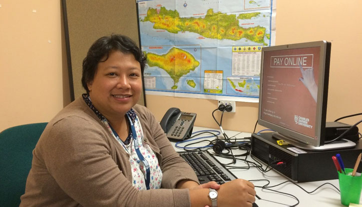 CDU student Dina Widyaputri Kariodimedjo sits at her desk