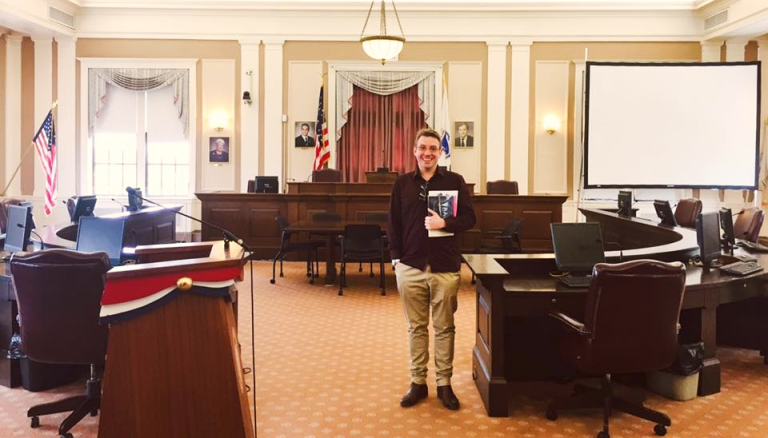 CDU student Paul Larder in a courtroom at Harvard Law School