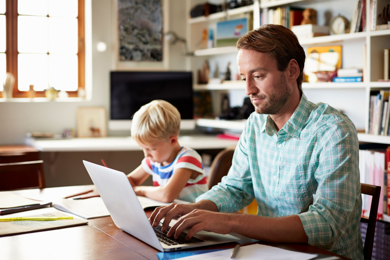 Man studying at home with kid