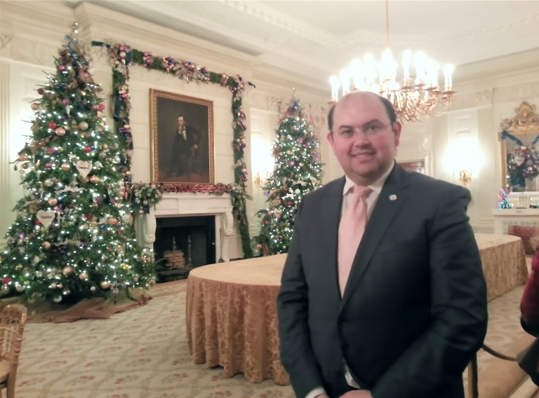 Emre smiling inside a room of the White House
