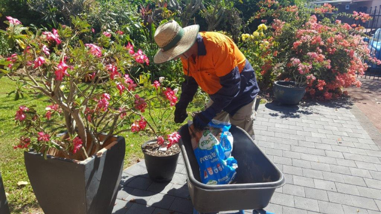 John preparing potting mix for flower pots