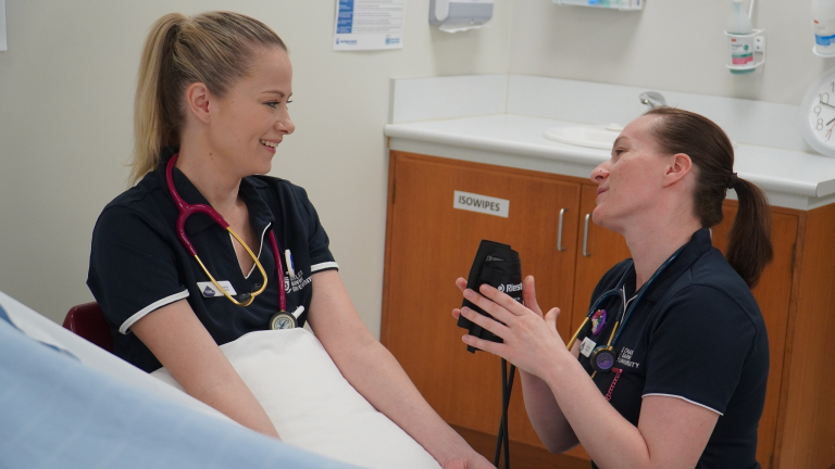 alicia burrows getting heart rate checked by coworker