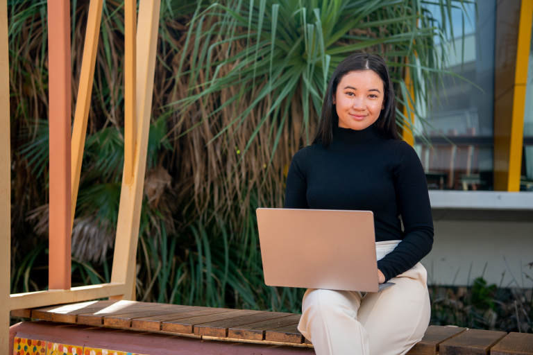 Student sitting with laptop 