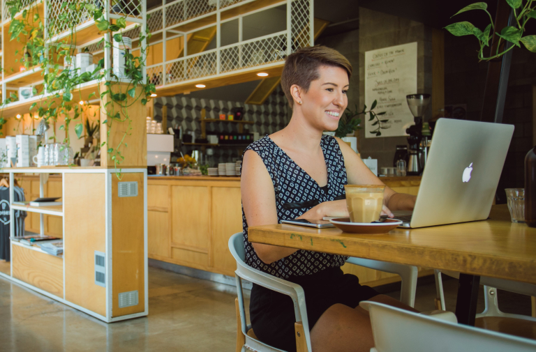 Creative arts student studying on laptop in cafe