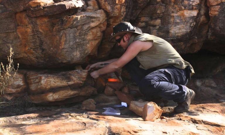 Kade Skelton conducting research out in the field