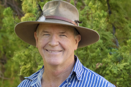 Prof Stephen Garnett head and shoulders, wearing hat, with green leafy background
