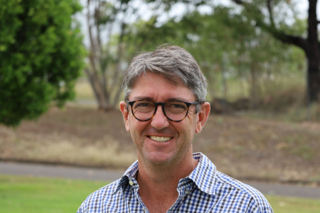 Michael Thomson, head and shoulders, with grass and trees in background