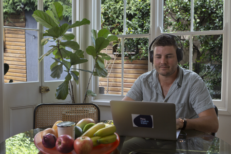 student on a telehealth appointment at home dining table