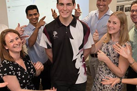 IT student Ashley Ferguson (centre) with Code Fair judges. Photo: Julianne Osborne