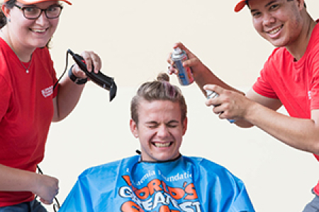CDU Student Ambassadors April Payne and Patrick Chin prepare for the World’s Greatest Shave. Pictured with Augustine Thorbjornsen
