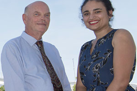 DVC Research and Research Training Professor Lawrence Cram celebrates with Minister for Environment and Natural Resources Ms Lauren Moss