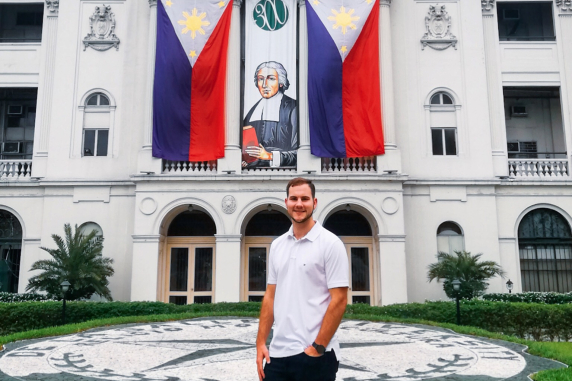 Joel standing in front of De la Salle University