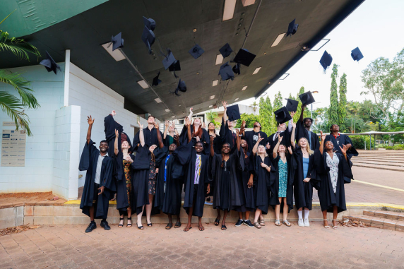 Aspire students throwing graduation caps
