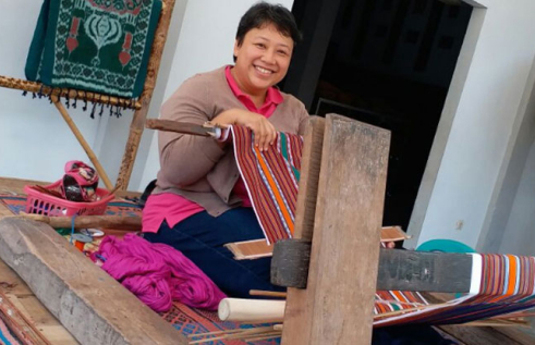 CDU student Dina Widyaputri Kariodimedjo on a loom