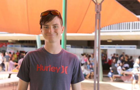 Nathaniel outside and smiling at the camera