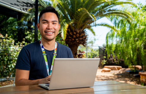 Alumni Awards finalist Ira Racines on laptop at headspace Darwin