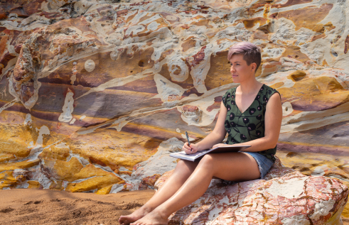 Creative arts student Allyce sitting outdoors
