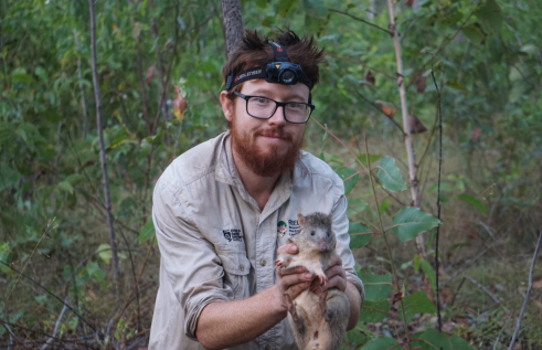 Researcher Alex with native small mammal